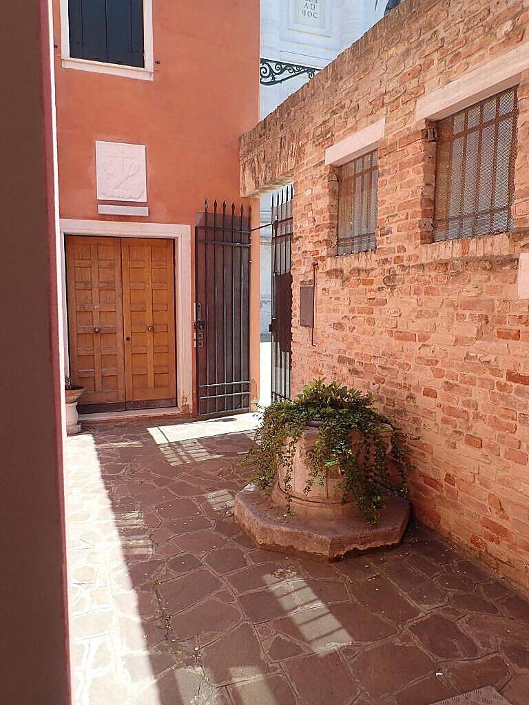 A flowerpot in a private courtyard which is actually a wellhead
