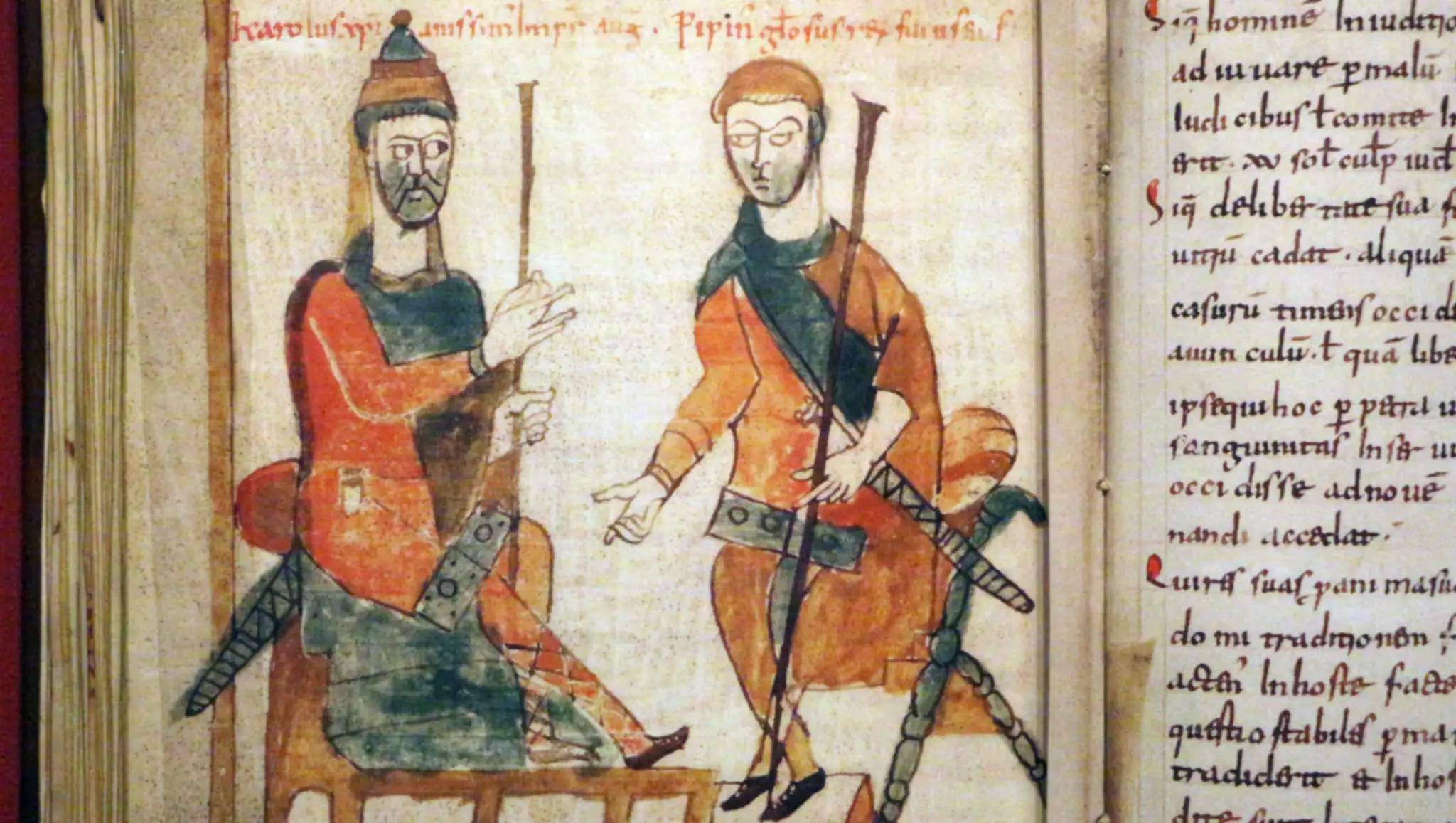 A coloured  illustration from the "Liber legum of Lupus of Ferrières", a manuscript from the late 800s or 900s. Charlemagne on the left is sitting on a throne, while Pepin stands in front of him, armed.